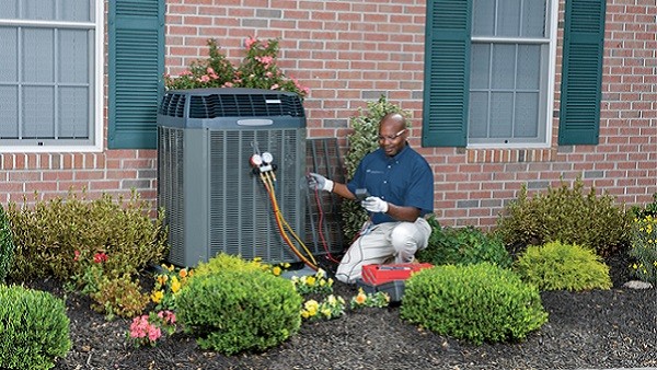 man fixing residential a/c system
